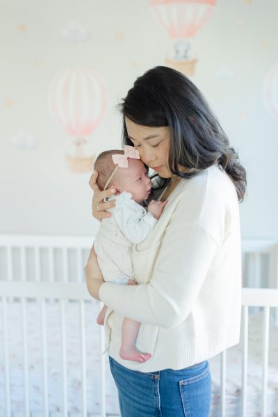A mom hugs her baby to her cheek in the nursery in Westfield NJ.