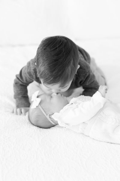 westfield nj baby photos 2 A young boy kisses his baby sister on the nose in Westfield NJ.
