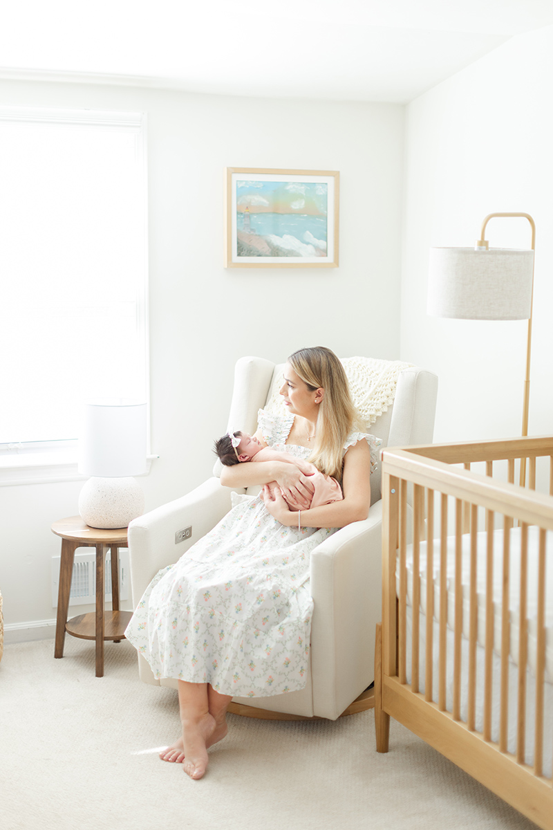 Mom sitting with newborn baby at home for NJ Newborn photographer Erin Dwyer Photography.
