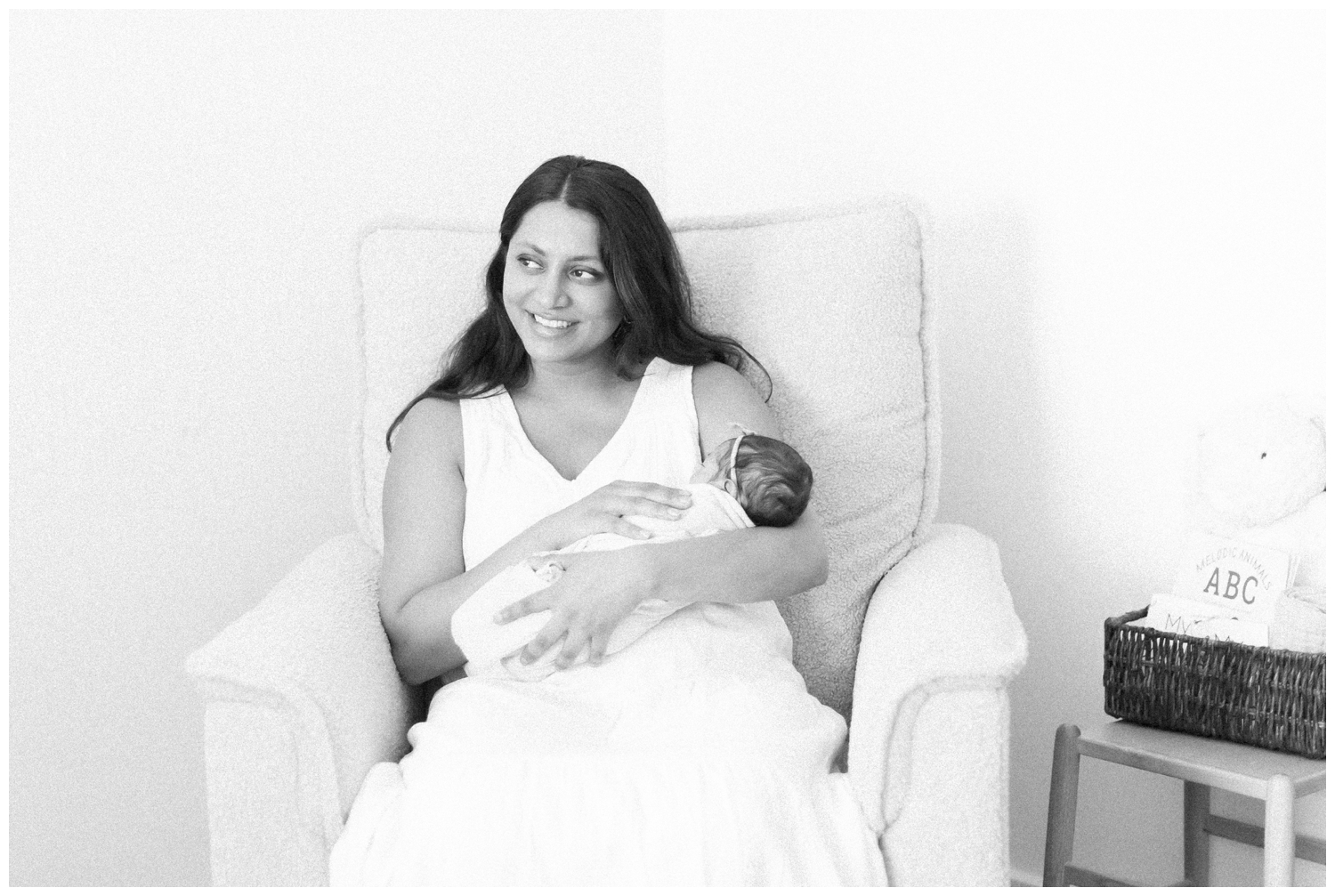 what-to-expect-during-your-newborn-session 0003 Mom smiling with her newborn daughter in her home in NJ.
